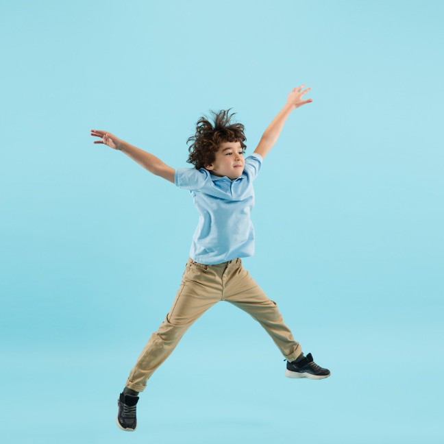 Child jumping joyfully during an ADHD-support gymnastics session
